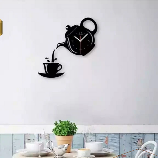Wall clock designed like a teapot pouring tea into a cup on a white wall.