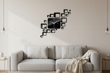 Black square wall clock with decorative square decals on a light gray background