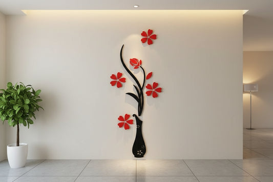 Decorative wall art with red flowers and a black vase on a wall.